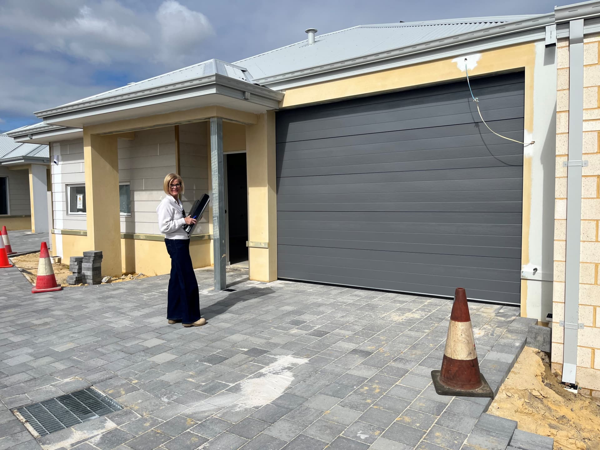 Completed frontage of one of the Bentley SDA homes, with paved driveway and letterbox