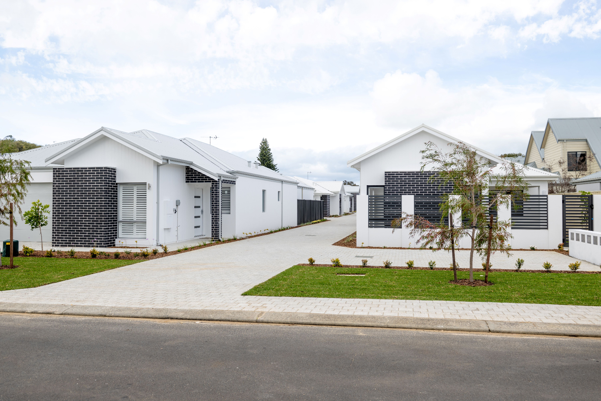 Pulse residential streetscape of single-storey homes with white weatherboard and dark brick facades, Perth Western Australia