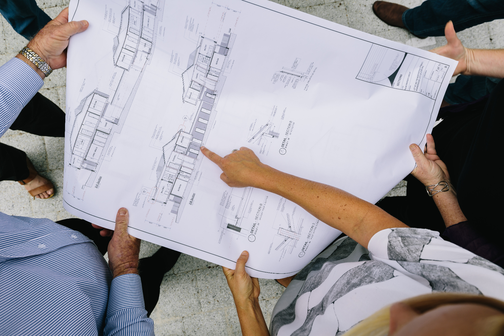 Pulse team and clients reviewing architectural plans on site, Perth Western Australia